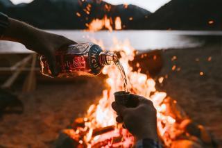 Whiskey bottle over fire